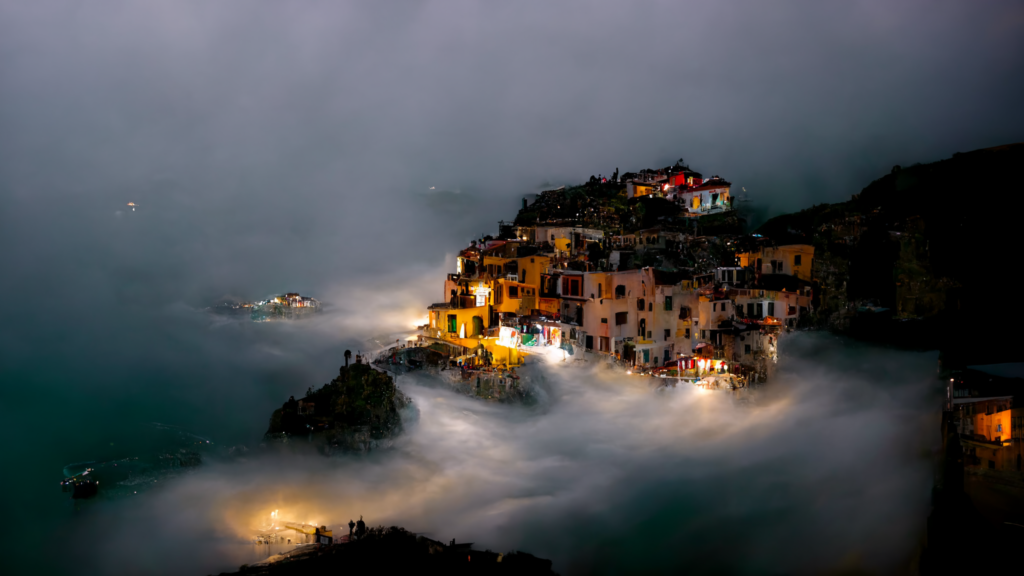 A photo of the Italian coast: a village of homes built into a cliff on a foggy day.